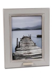 Photo frame with small tube for cremation ashes