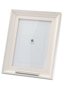 Wooden photo frame with small tube for cremation ashes