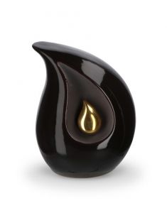Teardrop cremation urn for ashes made of black ceramic with small gold-colored teardrop